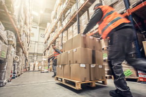 man pushing palette in warehouse