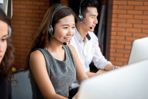 Smiling businesswoman working in call center