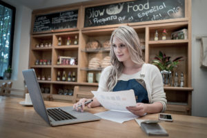 Business woman doing the books at a restaurant