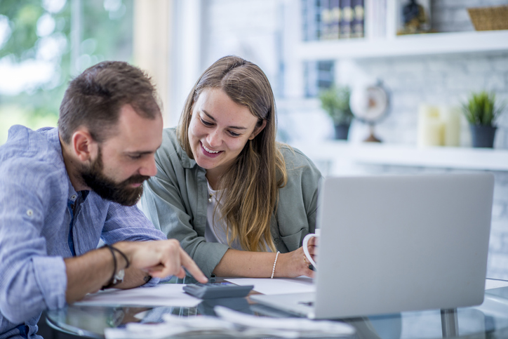 Two Business People Calculating Finances