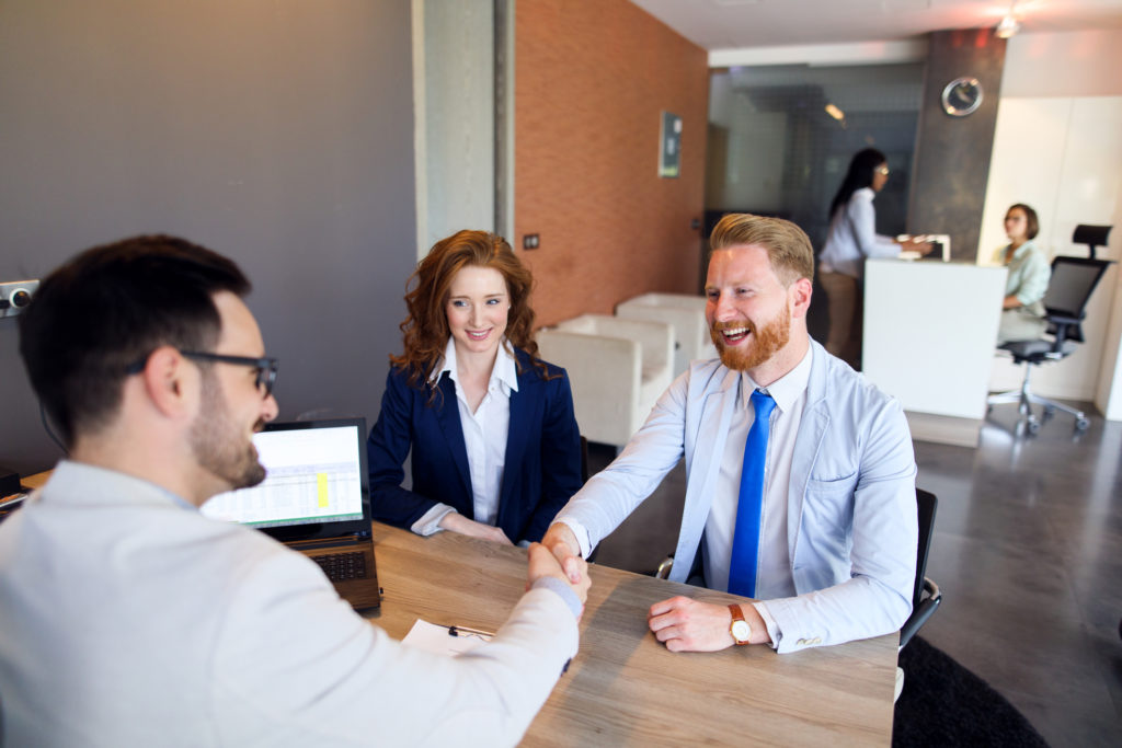 man shakes loan officer's hand