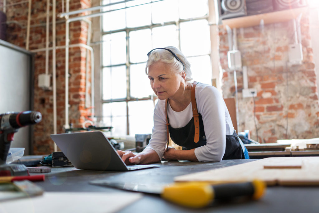 Businesswoman using a laptop in a workshop