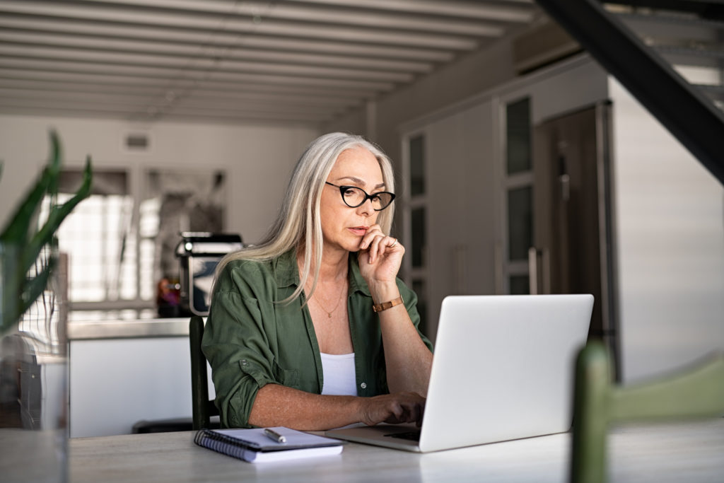 Illustrative photo of a woman looking at her laptop