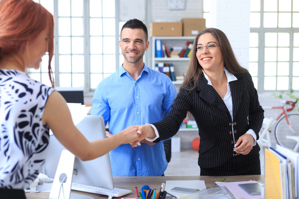 People in office shaking hands