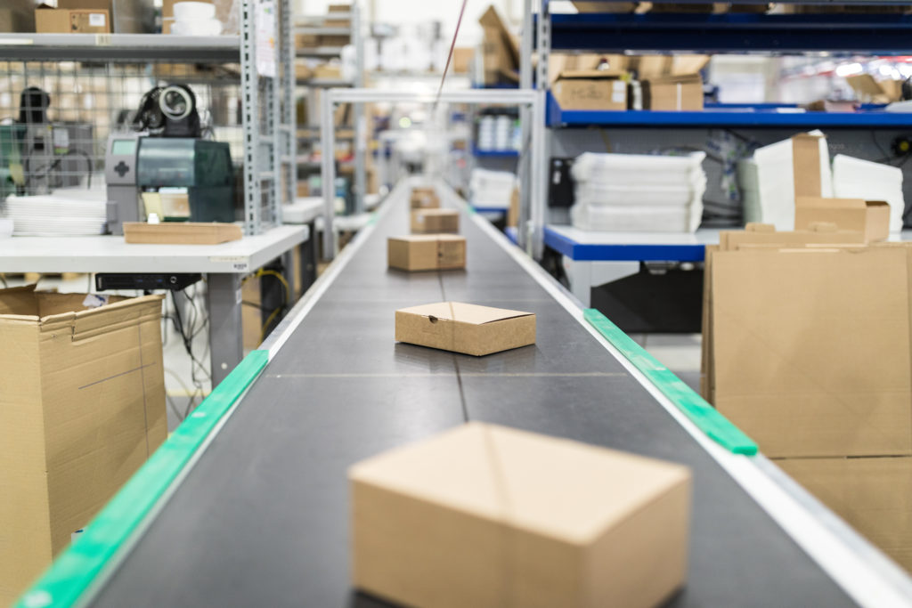 Boxes on a conveyor belt in a warehouse.