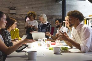 group-of-adults-sitting-around-a-conference-table