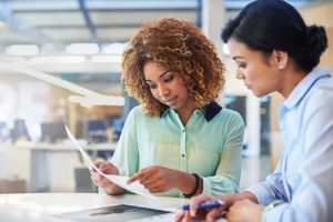 two women in a conference room