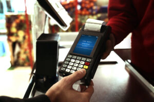 Featured image of a person entering payment information on a payment processor