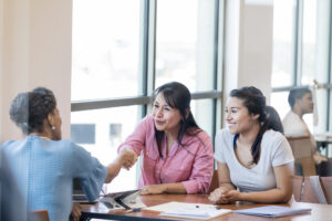 A businesswoman shakes hands with loan officer.