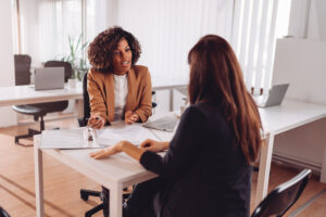 Featured image of a female banker showing documents to a female client