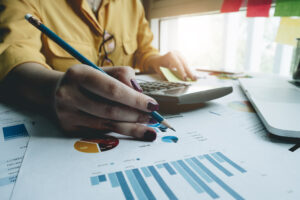 Featured image of a Black woman holding a pencil to calculate numbers