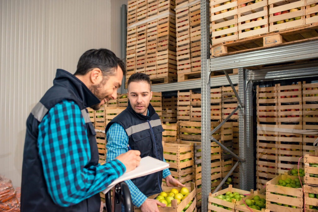 Featured image of two men stocking crates of fruits and vegetables in a warehouse