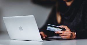 woman entering credit card information into a computer