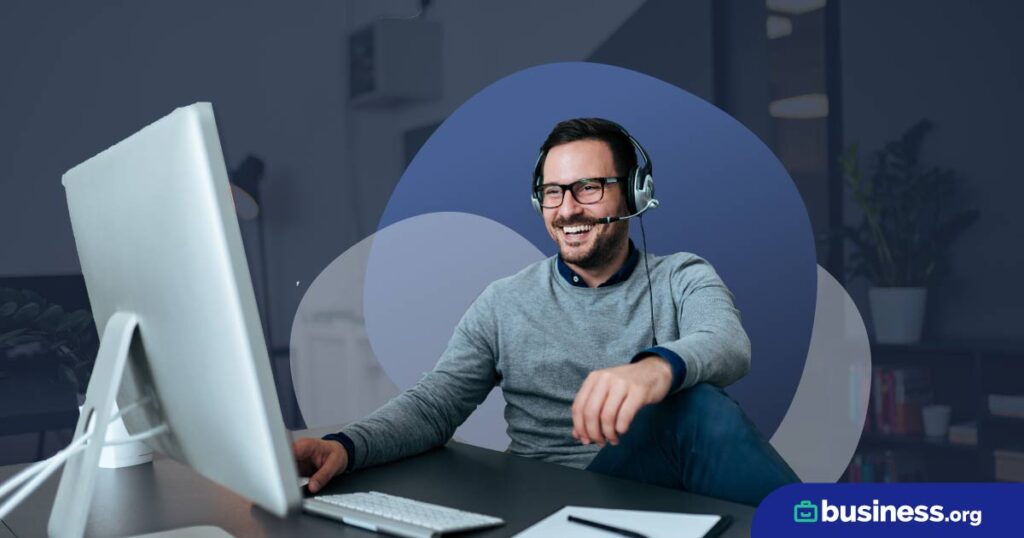 happy person using desktop wearing headphones