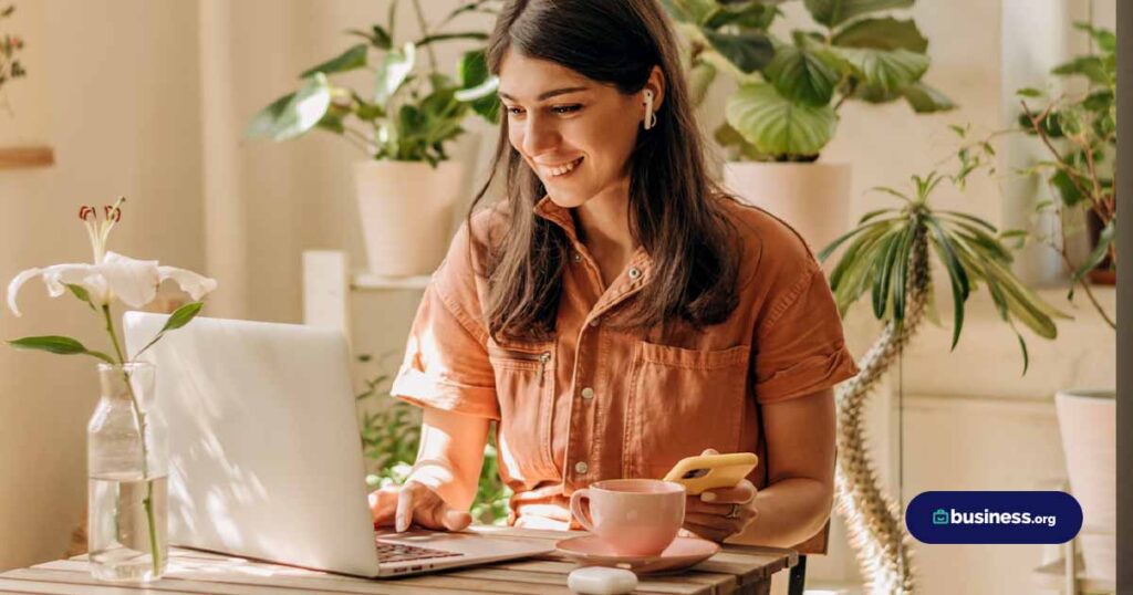 woman using laptop in a plant shop