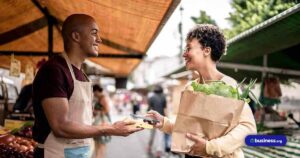 business-owner-at-farmers-market-with-client