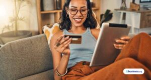 business-owner-sitting-on-couch-with-credit-card