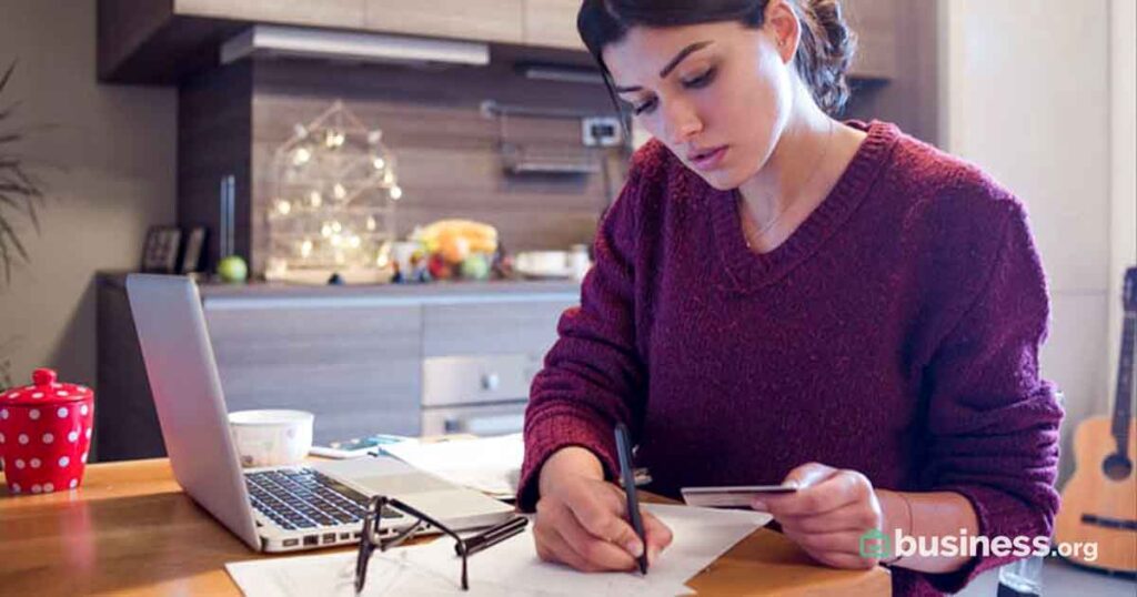 young woman paying bills from home