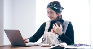 woman-working-at-computer-baby-wearing