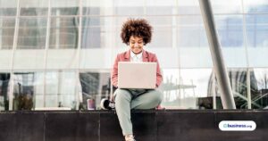 woman-sitting-outside-using-work-computer