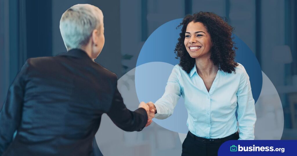 two people shaking hands on an abstract background