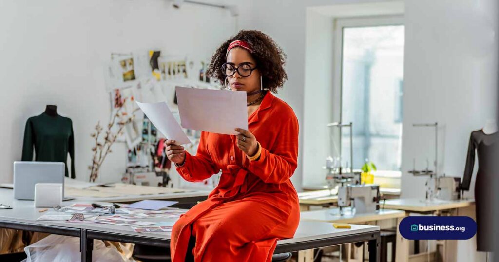 woman in fashion looking at paperwork